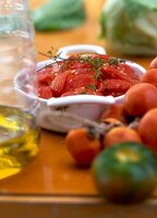 Close-up of confit and fresh tomatoes in cooking dish