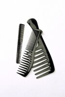 Three black combs on white background