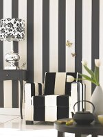 Black and white striped armchair in front of black and white striped wall
