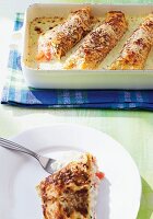 Basil crepes with tomatoes on baking tray and plate