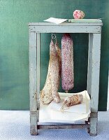 Four different types of Italian salami on stool