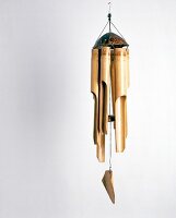 Wind chime made bamboo and coconut against white background