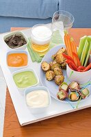 Beer, potatoes, finger food and dips on serving tray
