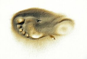 Footprint of man in sand on white background