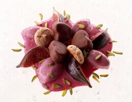 Close-up of caramel ice cream with red wine on white background