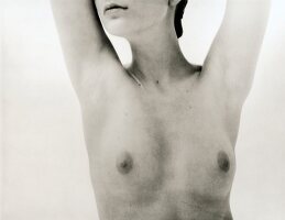Close-up of bare breasts of nude woman, black and white