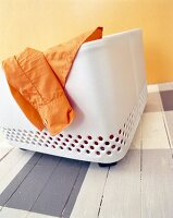 Close-up of orange shirt in white flowerbox on wheels