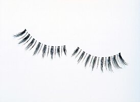 Black false eyelashes on white background