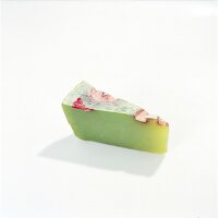 Piece of green soap flower on white background