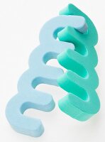 Close-up of blue and turquoise colour toe spreader in on white background