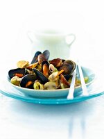 Close-up of Asian mussel with chopstick on white plate