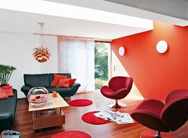 Wohnzimmer mit Ledersofa, Sessel Orangerote Wand