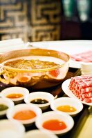 Feuertopf mit mongolischem Lamm und Saucen im Restaurant in Hongkong