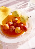 Apples and pears in glass bowl