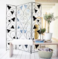 Transparent screen room divider with wrought iron leaf decor