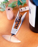 Corkscrew with wooden handle on table