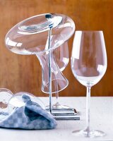 Decanter wine flask with stand and wine glasses on table