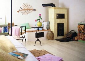 Bright room with fireplace, bench table, chair and white floorboards