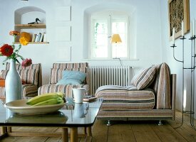 Three striped armchair with table, wooden floor and window in bright living room