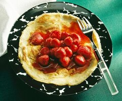 Pancakes with strawberry compote on plate