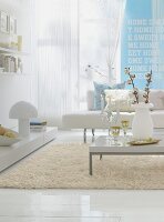 Living room with white sofa and light blue wall with text