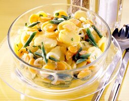 Close-up of potato salad with beans and carrots in glass bowl