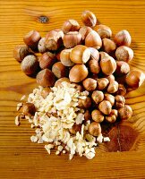 Close-up of large and small hazelnuts, chopped almonds