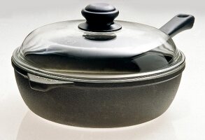 Close-up of frying pan with lid on white background
