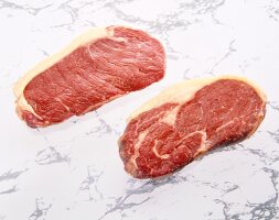 Two raw steaks