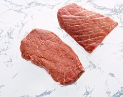 Two raw steaks