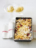 Nut Crumble with autumn fruits on baking tray