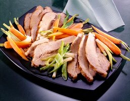 Marinated breast of veal with carrots, spring onions and ginger on plate