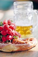 Pretzel and radishes on table