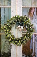 Dried wreath and statue of Blessed Virgin Mary