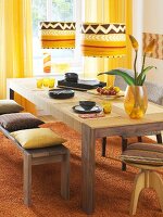 African styled dining room with wooden dining table and chair in yellow tones