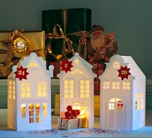 Illuminated house shaped advent calendar with numbers and Christmas decoration
