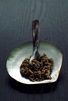 Russian caviar in serving shell with mother of pearl spoon