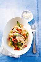 Fusilli served with asparagus and ham in serving dish