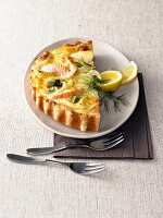 Fennel salmon quiche and lemon slices in dish