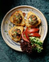 Baked rosti with beefsteak hack, tomatoes and lettuce in dish