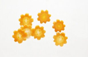 Floral shaped carrot slices on white background