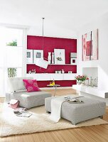 Living room with magenta and white walls, stools and armchairs