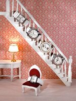 Close-up of watches set on staircase in dollhouse