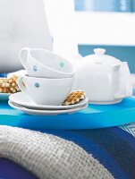 Two white cups and pot on plastic tray
