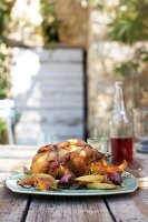 Guinea fowl wrapped in bacon with rosemary and melon on plate