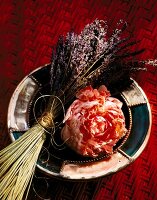 Close-up of peonies bloom and lavender on plate