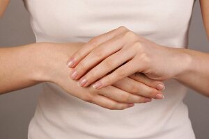 Close-up of woman applying lotion on her palms