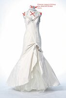 Close-up of white wedding dress on white background