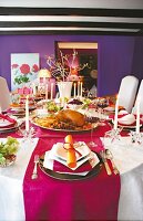 Opulent dining table laid with pink and white table cloth, goose with red wine