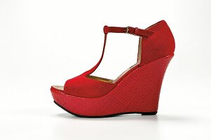 Red wedge heel on white background